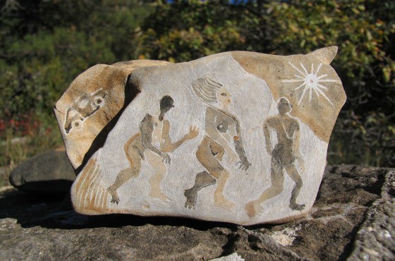 Rock art. Scraped and natural paint on stone.